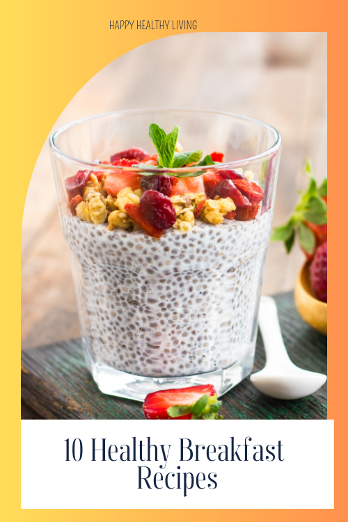 Chia breakfast pudding in a glass topped with nuts fruits and mint spring on a board with half a strawberry and a spoon. healthy breakfast recipes.